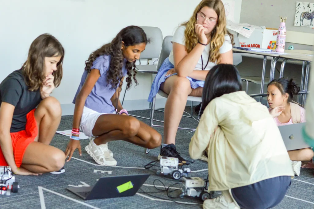 T.I.E. campers working together on a robotics challenge