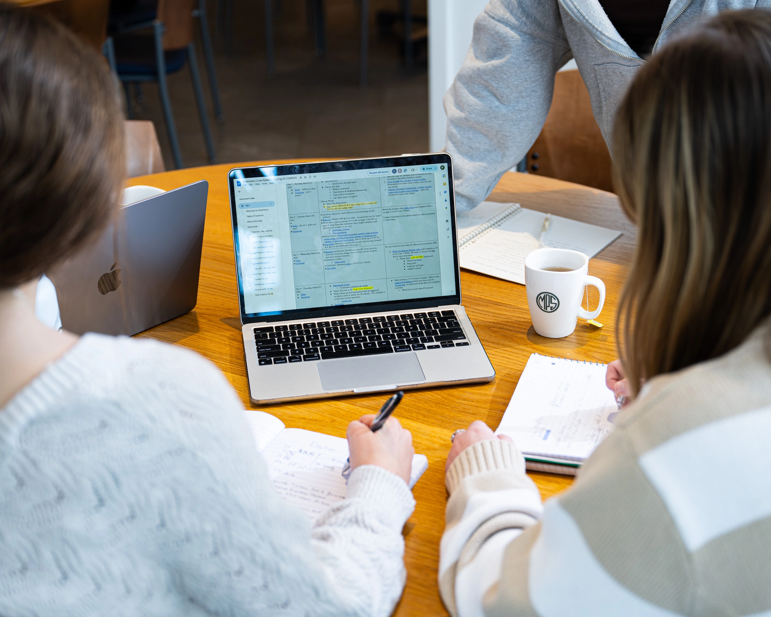 girls reviewing a spreadsheet at business summer camp